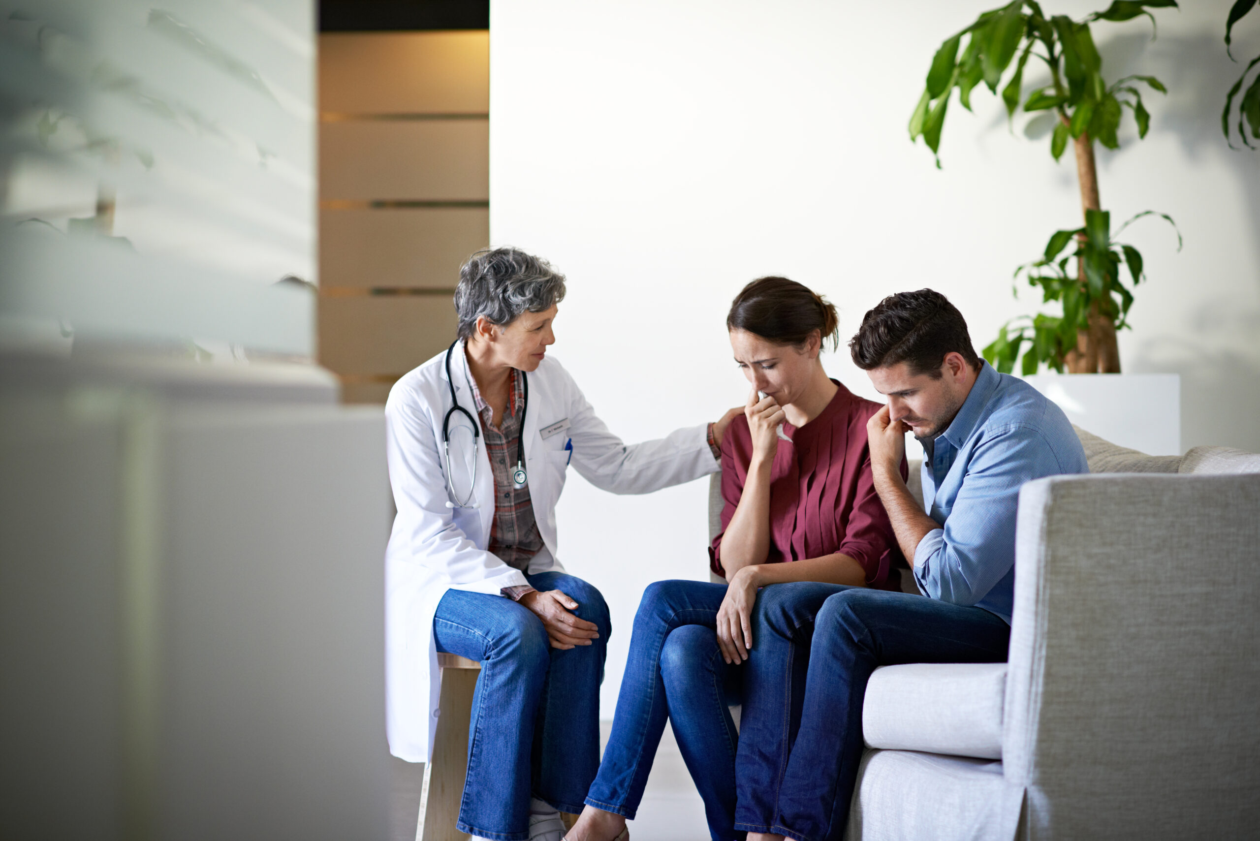 A doctor consulting with a visibly stressed couple maps directly onto the article's tone — fertility patients navigating an uncertain regulatory environment — and is the only candidate that captures the patient-provider relationship central to an IVF/FDA piece.