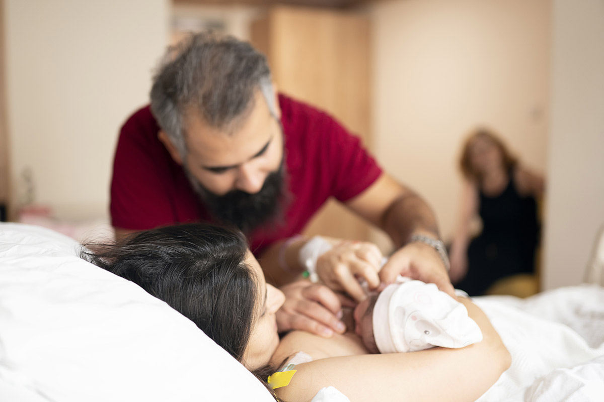 A real GOP-library newborn moment with both parents present powerfully anchors the 'why we fight' emotional core of an infertility advocacy article — the outcome that policy either enables or blocks.